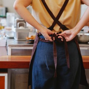 Worker wearing a kitchen apron