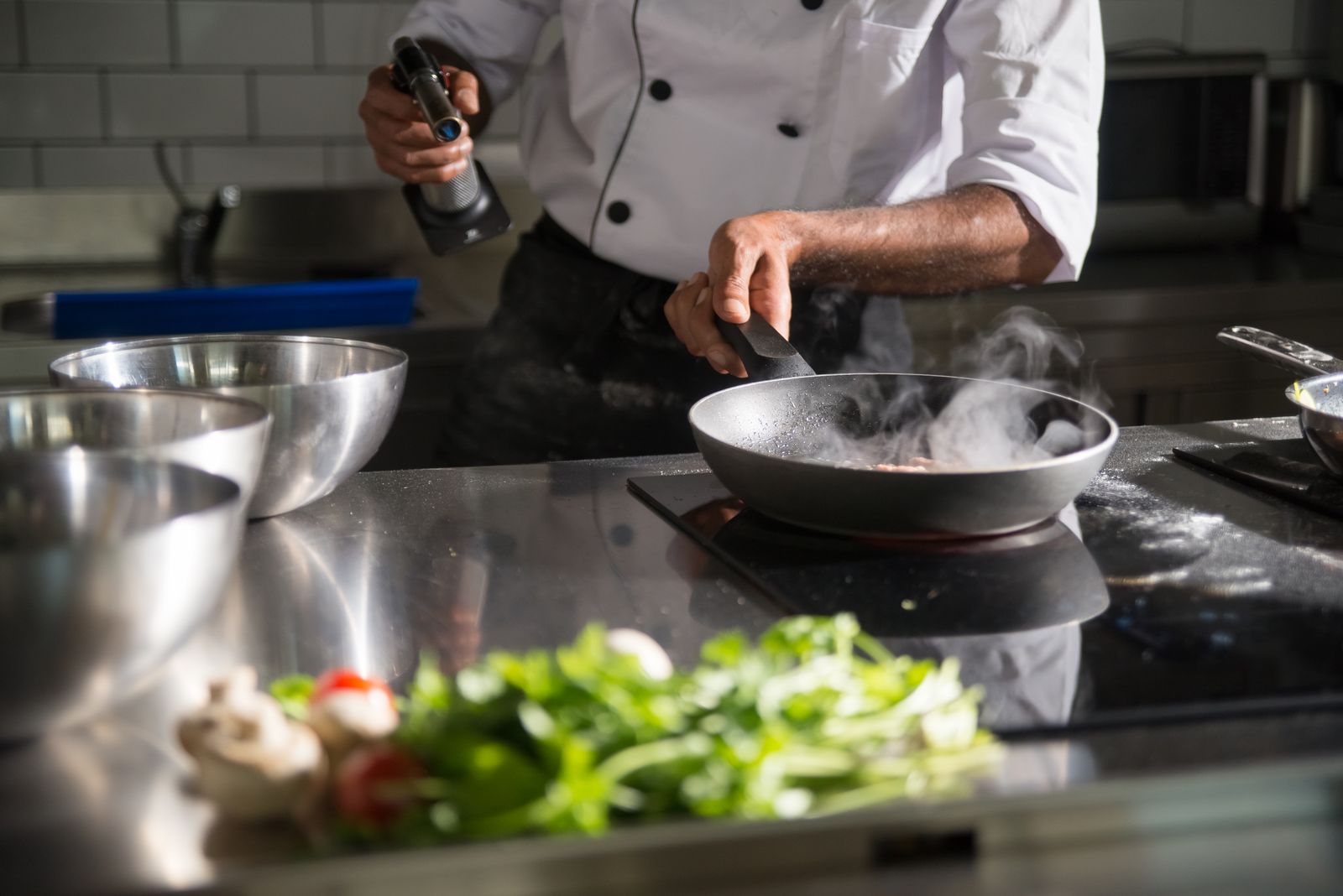 Chef Coat 1 Chef cooking in a kitchen