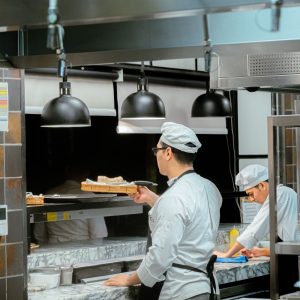 Chefs in whites in a commercial kitchen