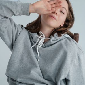 Woman wearing a grey hoodie
