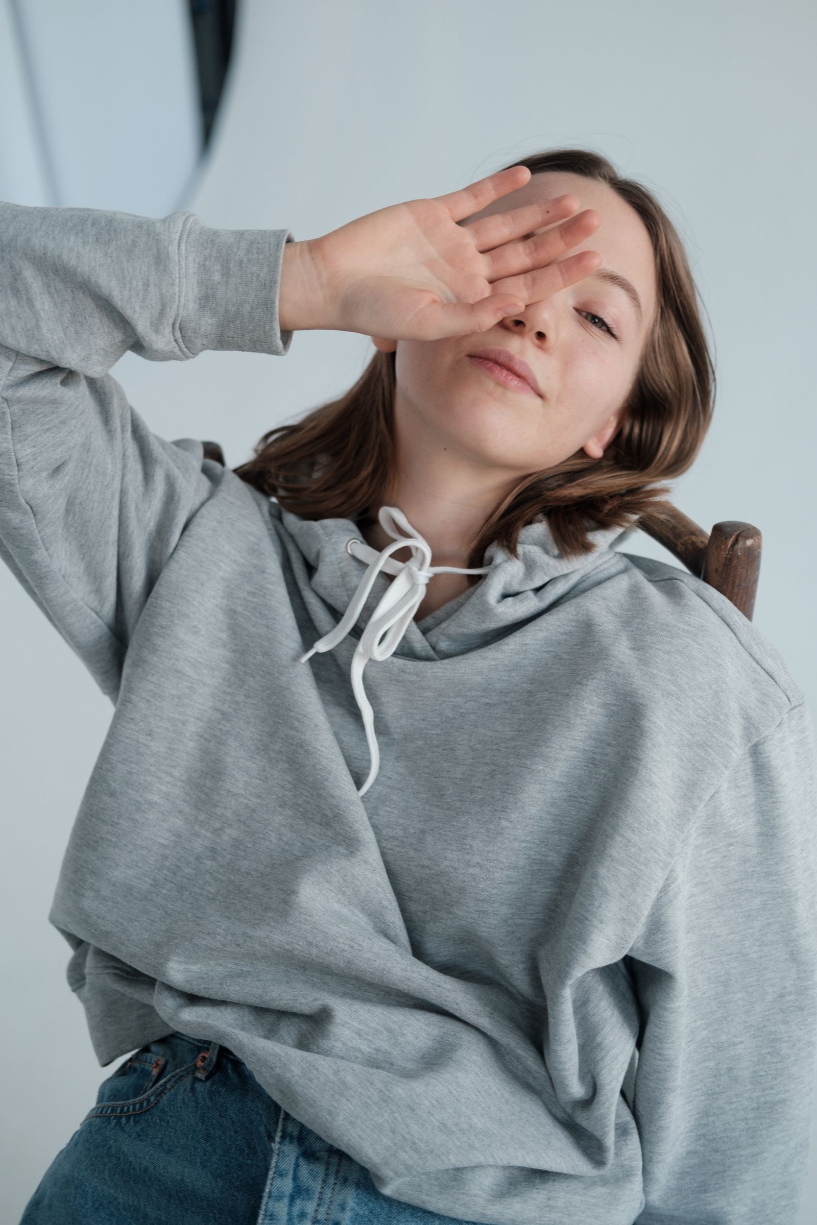 Custom Logo Hoodie 1 Woman wearing a grey hoodie