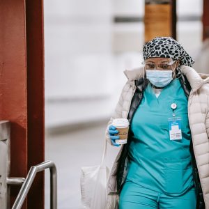 Healthcare worker in hospital uniform and mask