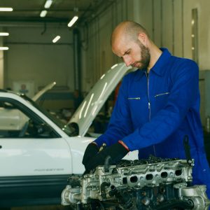 Mechanic wearing a blue coverall uniform
